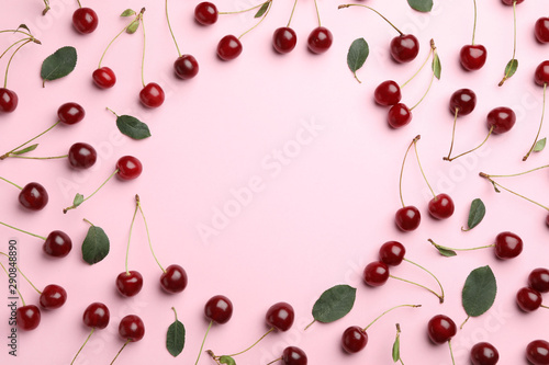 Delicious cherries on pink background, flat lay. Space for text