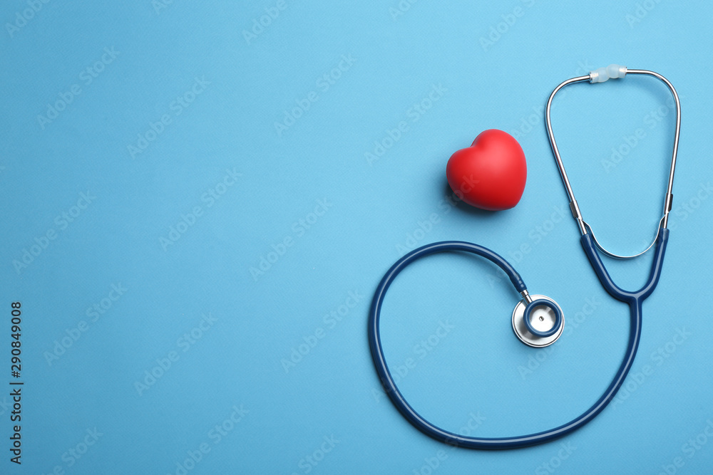 Stethoscope, red heart and space for text on blue background, flat lay. Health insurance concept Stethoscope, red heart and space for text on blue background, flat lay. Health insurance concept