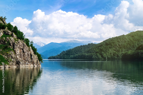 Picturesque view of beautiful lake surrounded by mountains on sunny day © New Africa