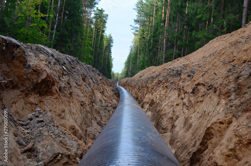 Natural gas pipeline construction work. A dug trench in the ground for the installation and installation of industrial gas and oil pipes. Underground work project photo