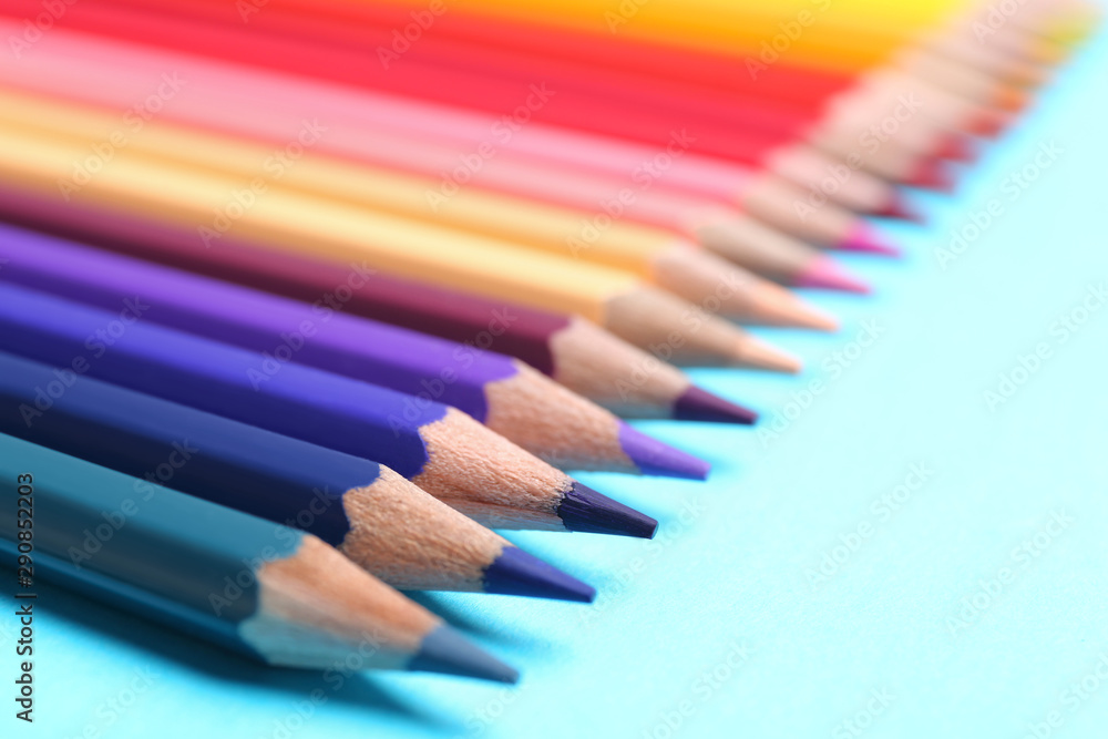 Colorful pencils on light blue background, closeup Colorful pencils on light blue background, closeup