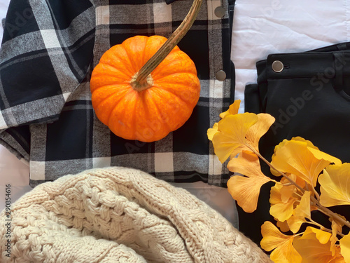 Women's fall fashion flat lay - cozy scarf, flannel shirt and black pants