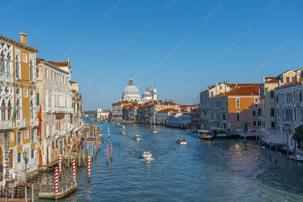  Beautiful Venetian view with Grand Canal, Basilica Santa Maria della Salute and traditional gondolas, in Venice, Italy