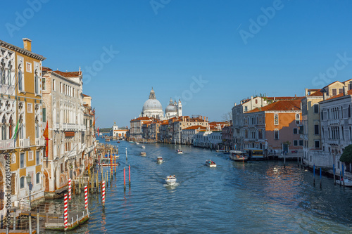  Beautiful Venetian view with Grand Canal, Basilica Santa Maria della Salute and traditional gondolas, in Venice, Italy © Aron M  - Austria