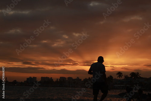 silhouette of man on background of sunset