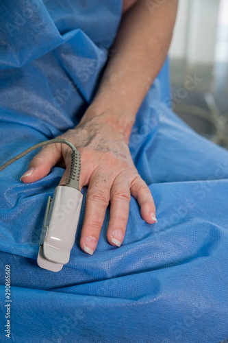 Closeup of female hand with finger pulse oximeter