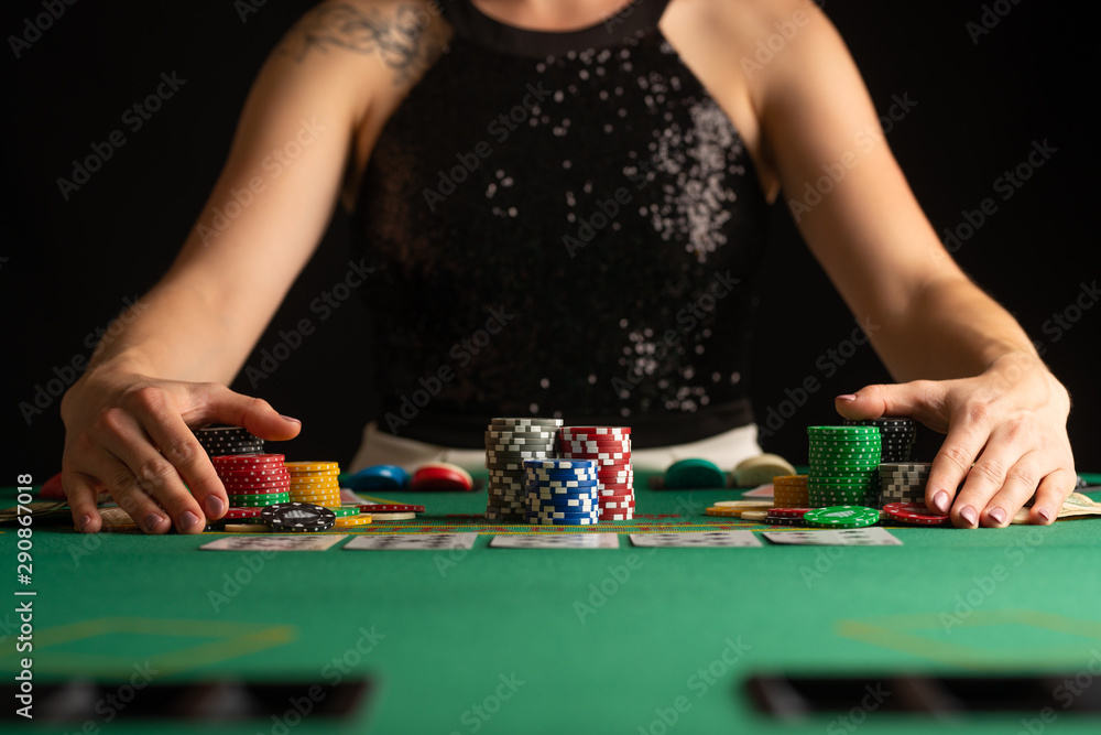 The girl won everything and takes all the chips, Playing in a casino, poker. Focus and focus on the chips. Raising bets, gaming business The girl won everything and takes all the chips, Playing in a casino, poker. Focus and focus on the chips. Raising bets, gaming business