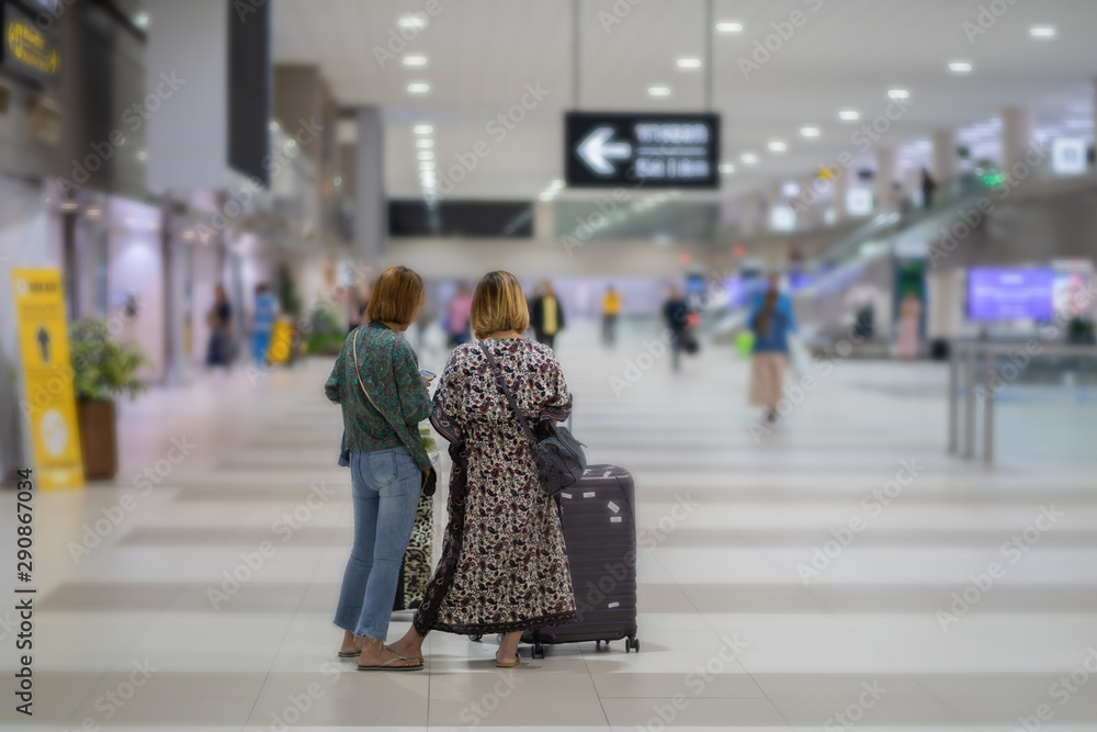 Travel concept, people in the airports ,young girl or women carries luggage walking at the airport terminal.selective focus,vintage tone color Travel concept, people in the airports ,young girl or women carries luggage walking at the airport terminal.selective focus,vintage tone color