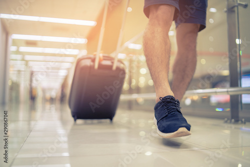 Travel concept  people in the airports  young  boy or man carries luggage walking at the airport terminal.selective focus vintage tone color