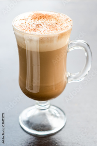 cup of coffee with cream on white background