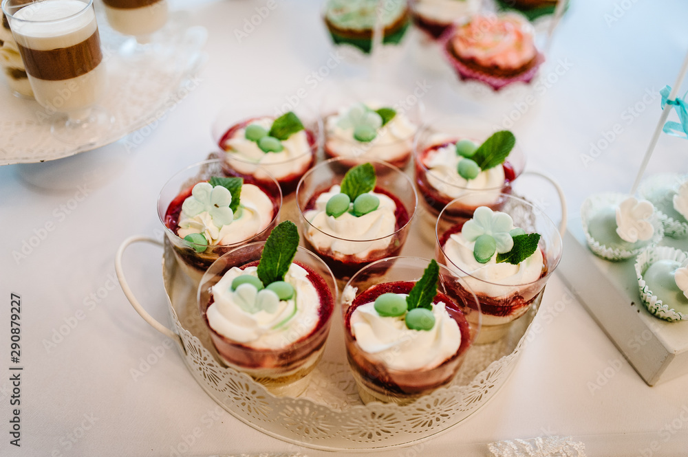 Dessert table for a party. cakes, pie, cupcakes. Colorful table with sweets and goodies for the wedding party reception, decorated dessert table. Delicious sweets on candy buffet. Dessert table for a party. cakes, pie, cupcakes. Colorful table with sweets and goodies for the wedding party reception, decorated dessert table. Delicious sweets on candy buffet.