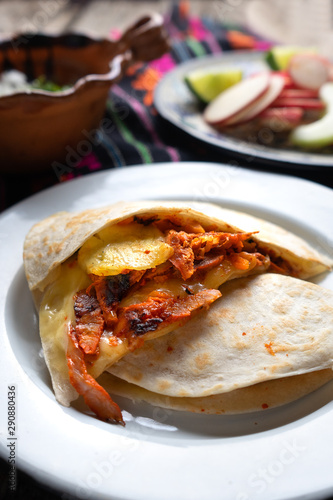 Mexican quesadilla with pork also called "gringa al pastor"
