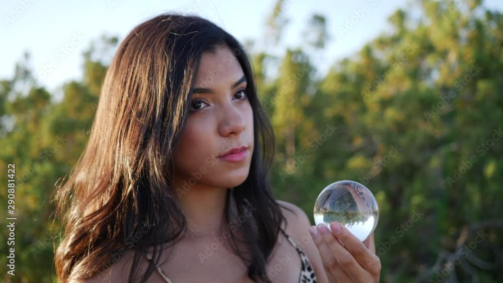 A gorgeous woman wizard in a mystical fantasy land casting a spell or enchantment with her magic crystal ball CLOSE UP. A gorgeous woman wizard in a mystical fantasy land casting a spell or enchantment with her magic crystal ball CLOSE UP.