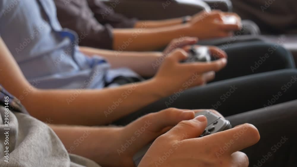 Three friends playing video games on wireless controllers. Friends competition in video games. Three friends playing video games on wireless controllers. Friends competition in video games.