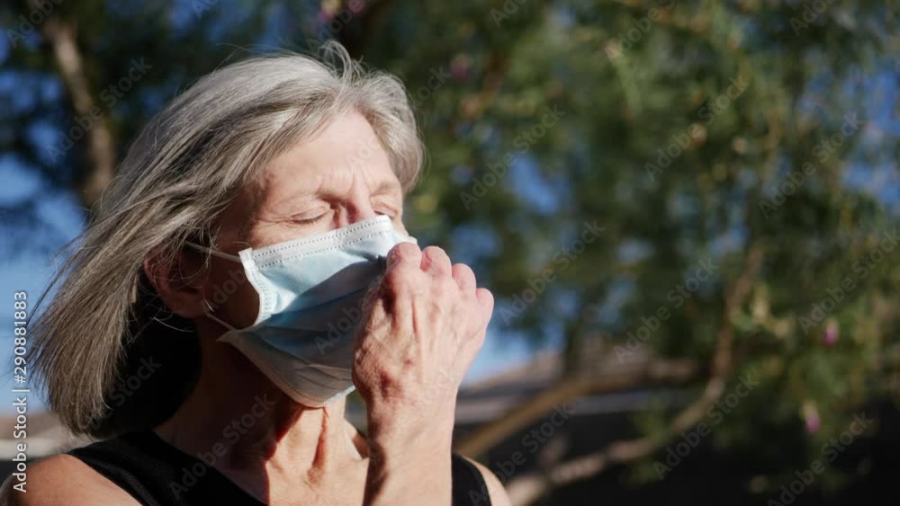 An aging woman patient with an illness breathing fresh air and smiling with hope after being treated for her disease. An aging woman patient with an illness breathing fresh air and smiling with hope after being treated for her disease.