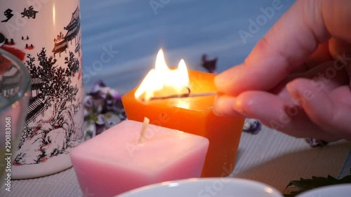 woman lights aroma candles. close-up