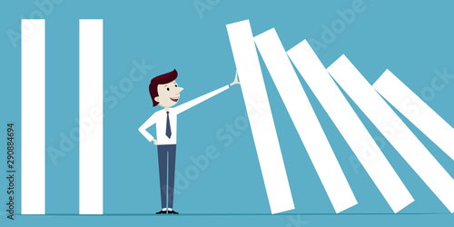 Businessman stops falling of domino