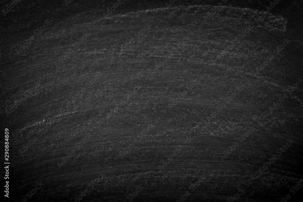 Fototapeta premium Working place on empty rubbed out on blackboard chalkboard texture background with colorful crayons chalk for classroom or wallpaper, add text message.