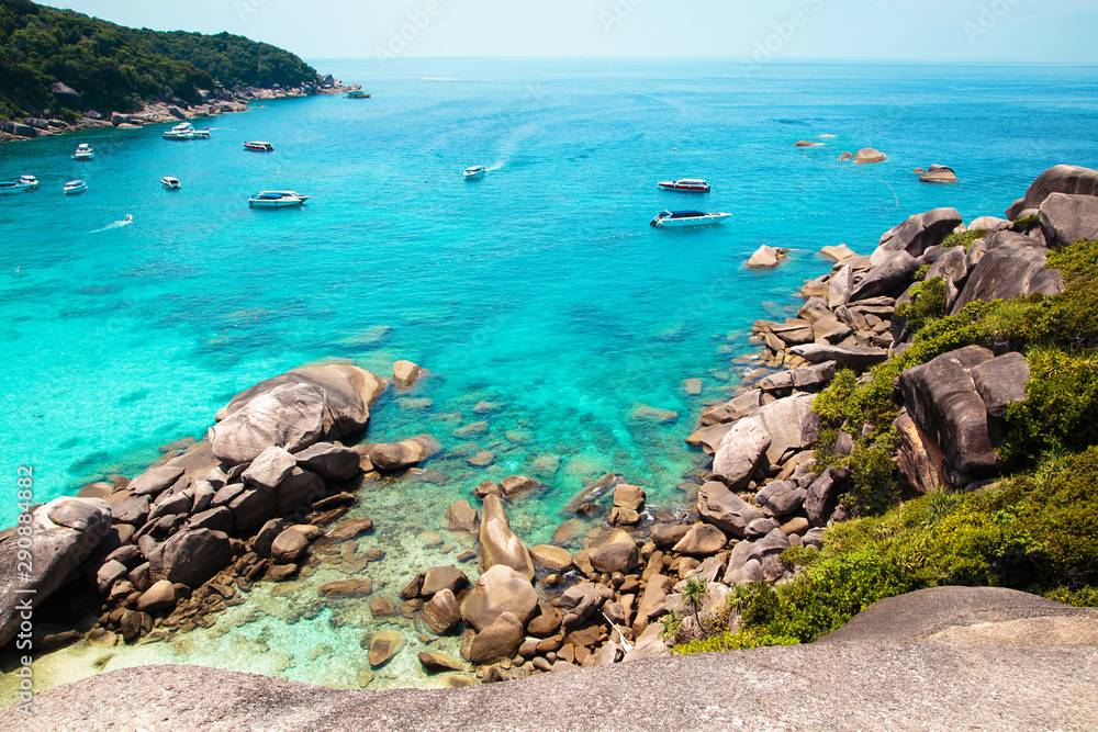 Similan Islands, Andaman Sea, Thailand, March 18, 2018: National park, beautiful blue sea. White boats with tourists. Similan Islands, Andaman Sea, Thailand, March 18, 2018: National park, beautiful blue sea. White boats with tourists.