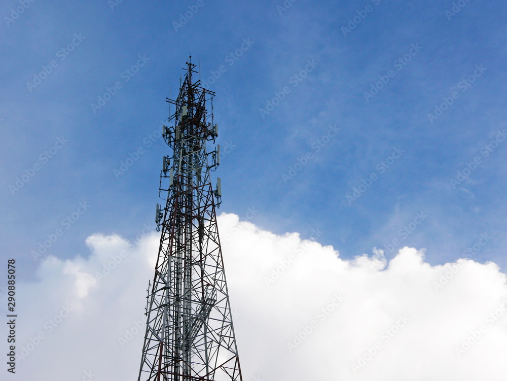Mobile phone tower on blue sky in a rural area of Thailand Mobile phone tower on blue sky in a rural area of Thailand