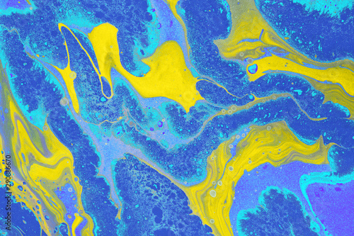 Acrylic Fluid Art. Free flow of yellow and blue colors creates marble effect. Abstract background or texture