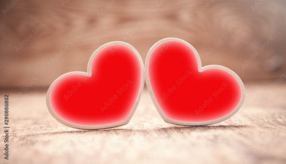 Fototapeta premium Wooden red hearts on wooden table.