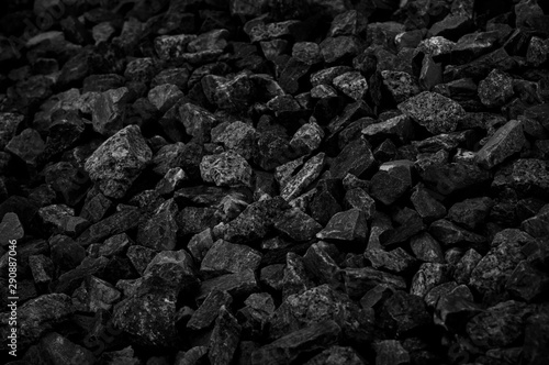 Natural fire ashes with dark grey black coals texture. It is a flammable black hard rock. Space for text. © NaPUN