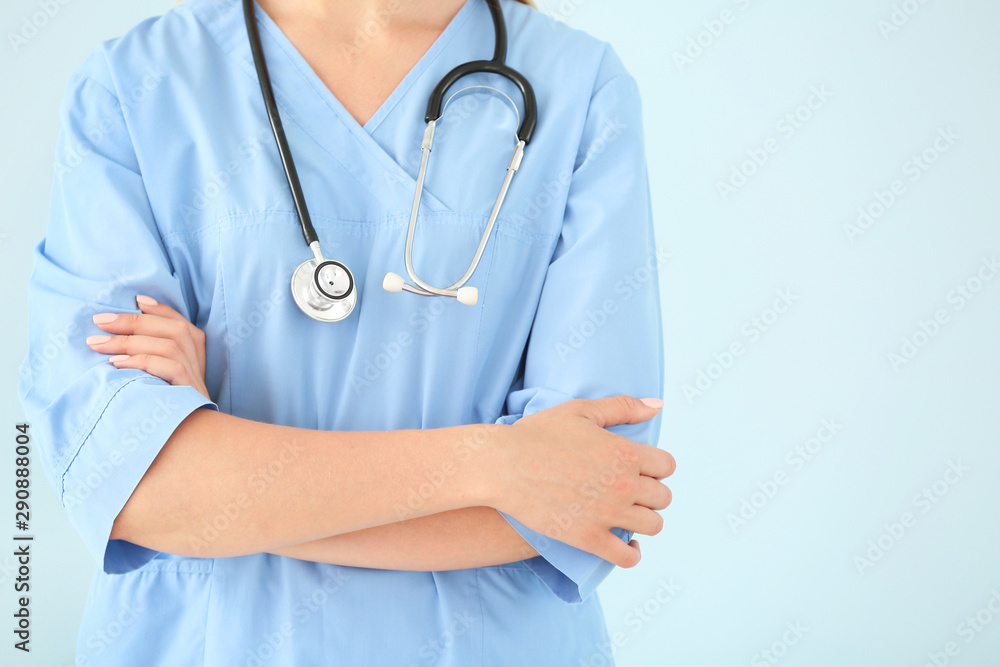 Female nurse with stethoscope on color background, closeup Female nurse with stethoscope on color background, closeup