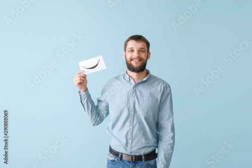 Happy man holding sheet of ...