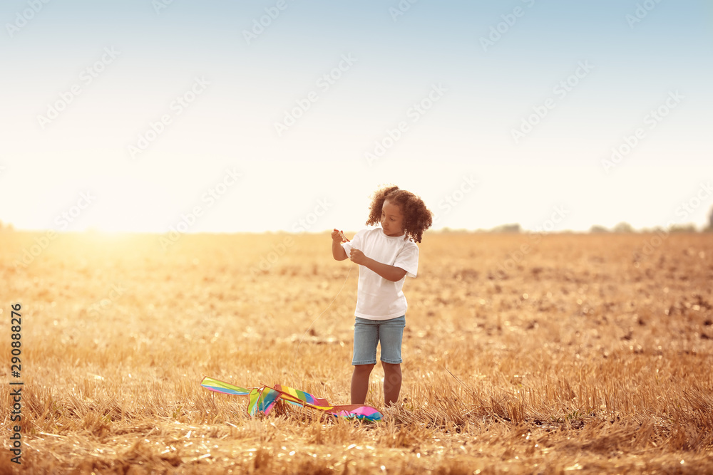 Little African-American girl flying kite outdoors Little African-American girl flying kite outdoors