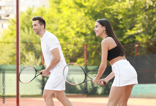 Young couple playing tennis on court © Pixel-Shot