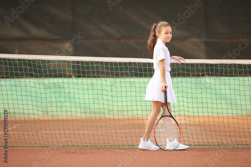 Little girl playing tennis on court © Pixel-Shot
