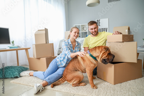 Happy couple with cute dog ...