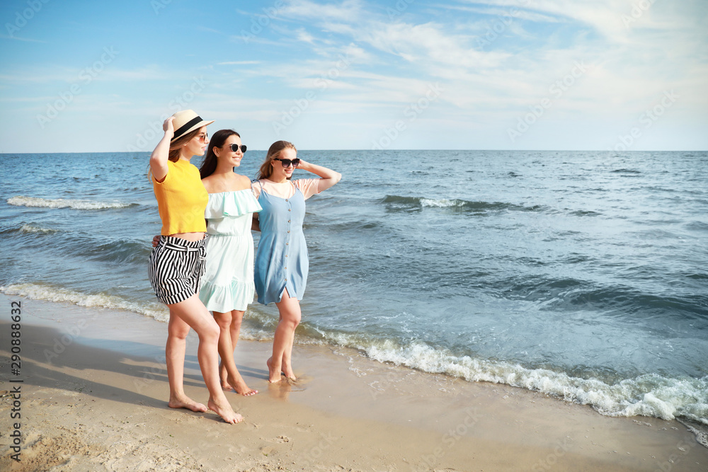 Happy young women on sea beach at resort Happy young women on sea beach at resort