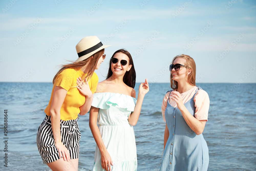 Happy young women on sea beach at resort Happy young women on sea beach at resort