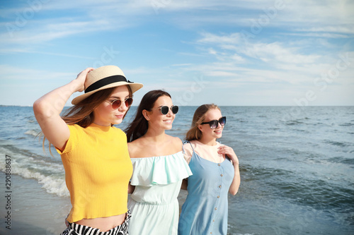 Happy young women on sea be...