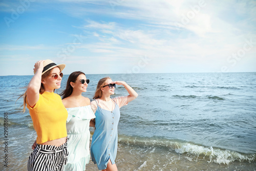 Happy young women on sea be...