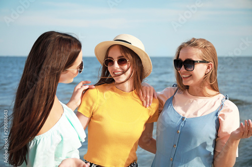 Happy young women on sea beach at resort © Pixel-Shot