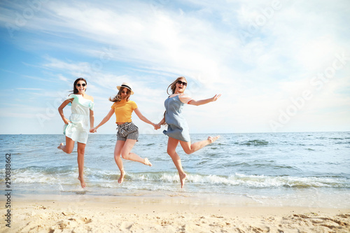Happy jumping young women o...