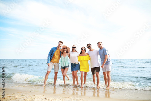 Happy friends on sea beach ...