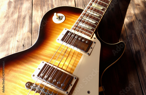 electric guitar on the wooden boards in the sun light  photo