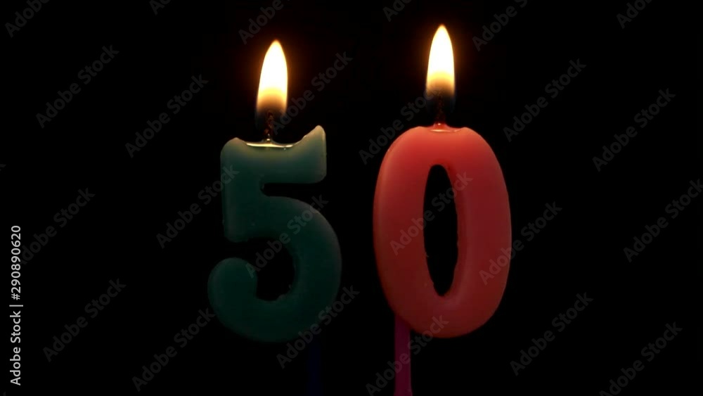 Burning birthday candles on black background, number 50 Burning birthday candles on black background, number 50