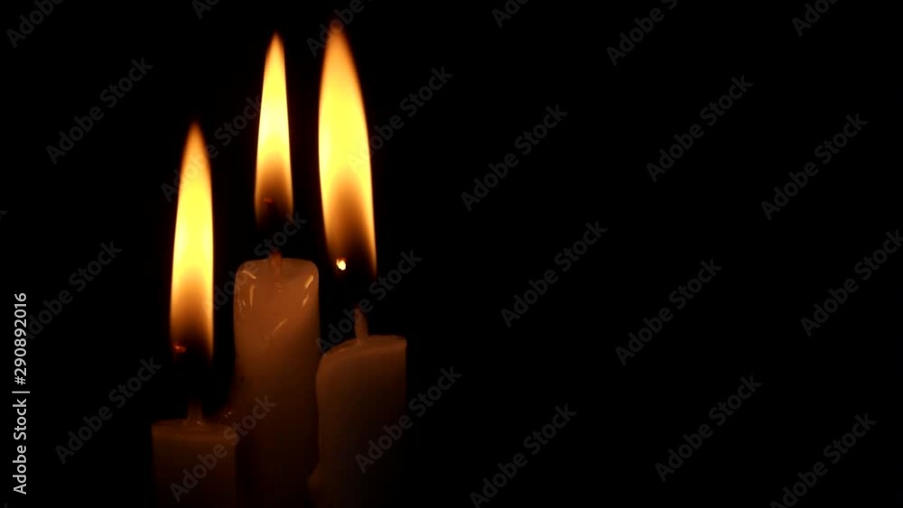 Three burning candles in darlness with space for text. Religion, funeral and memorial concept. Three burning candles in darlness with space for text. Religion, funeral and memorial concept.