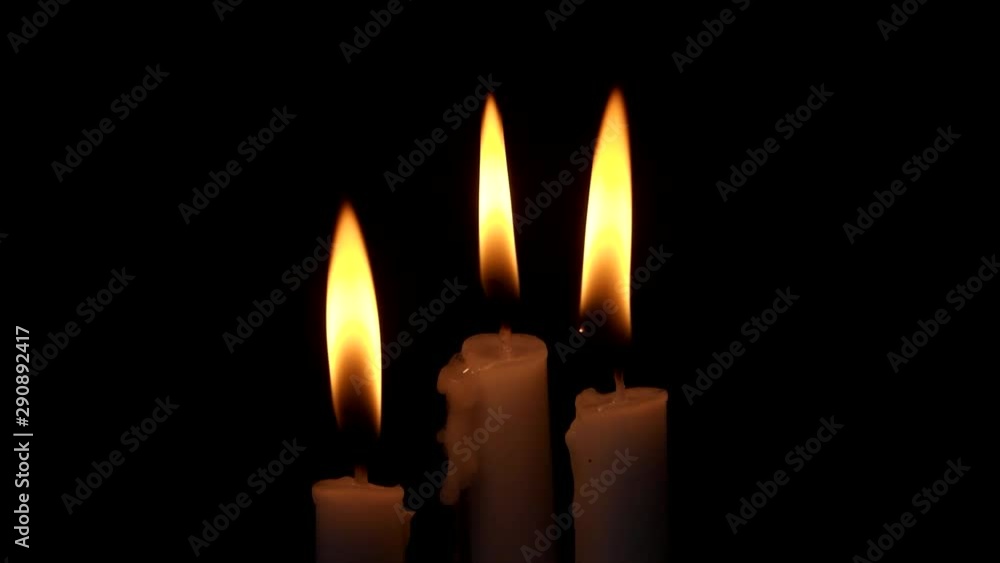 Candles burning and blowing out on black. Religion, funeral and memorial theme. Candles burning and blowing out on black. Religion, funeral and memorial theme.