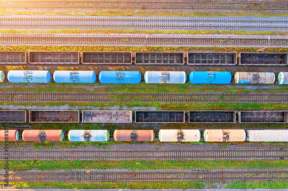Aerial view of rail sorting freight station with various wagons, with many rail tracks railroad. Heavy industry landscape.