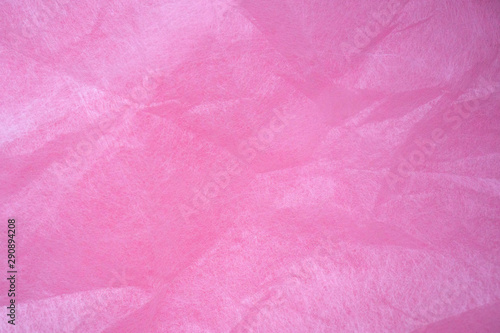 Pink crumpled wrapping paper background and texture. Tender pink background creates a romantic mood