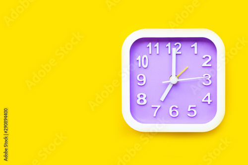 Clock on yellow background.