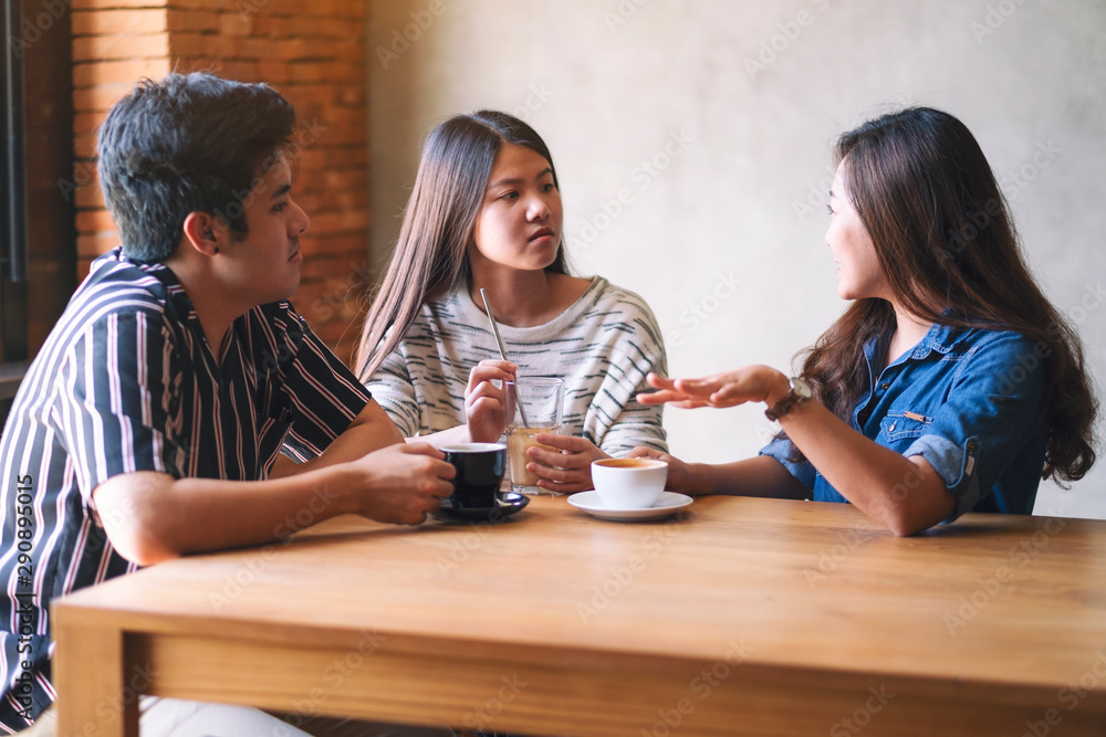 Closeup image of friends enjoyed talking and drinking coffee together in cafe Closeup image of friends enjoyed talking and drinking coffee together in cafe