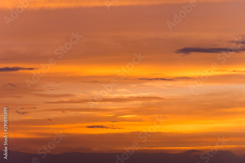Abstract nature background. Dramatic sunset sky in the clouds saturated with bright colors of orange and yellow. Contrast Low Key © yanik88