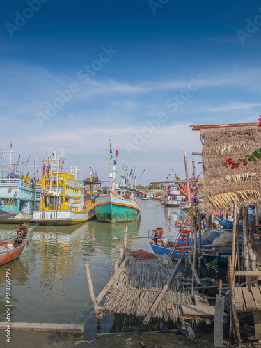 view of bamboo hut with many fishing boats floating in the sea, Puek Tian Fisherman Village, Phetchaburi, Thailand. photo